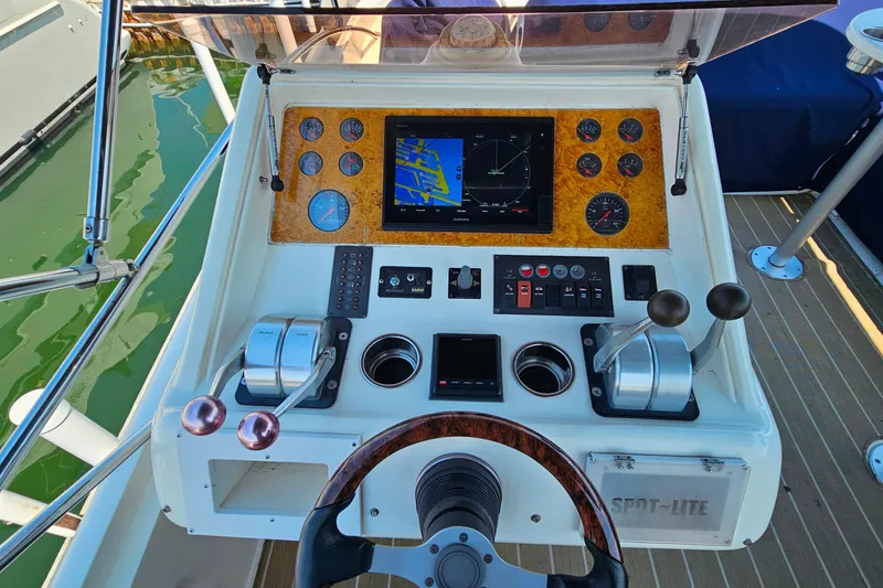 Slide: The Image of Cockpit of 1998 Sunseeker Manhattan 62 yacht with navigation controls and instruments. - 58