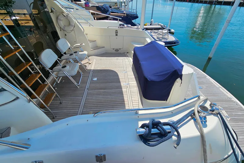 Slide: The Image of 1998 Sunseeker Manhattan 62 yacht deck with seating and covered equipment. - 7