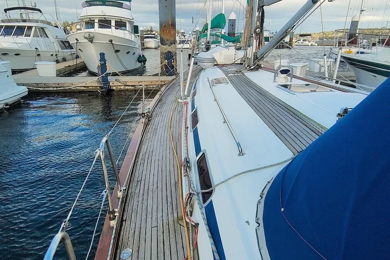 Slide: The Image of 2003 Bavaria 49 sailboat docked at marina with other boats. - 10
