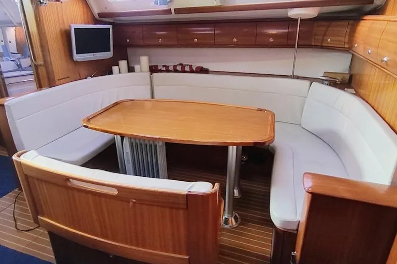 Slide: The Image of Interior of a 2003 Bavaria 49 yacht with a cozy dining area. - 21