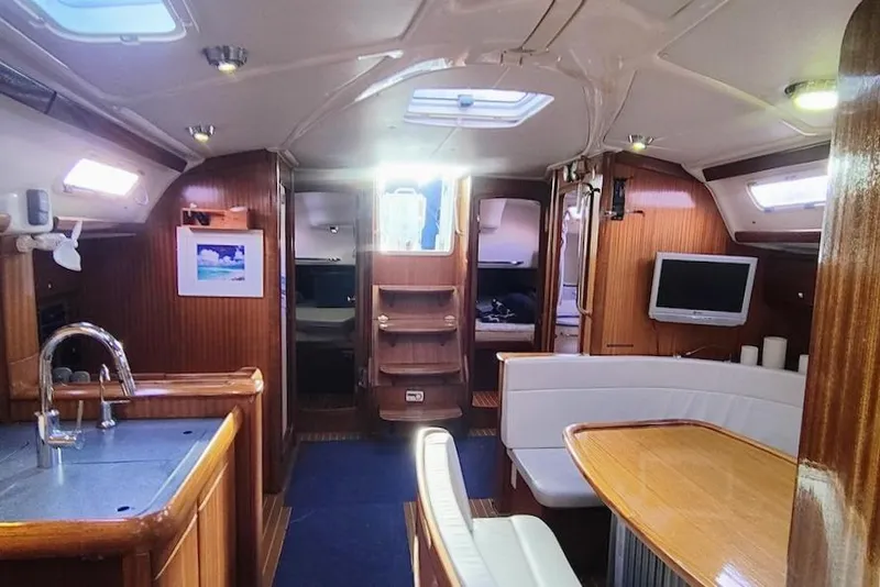 Slide: The Image of Interior of a 2003 Bavaria 49 yacht with wood finish and modern amenities. - 24