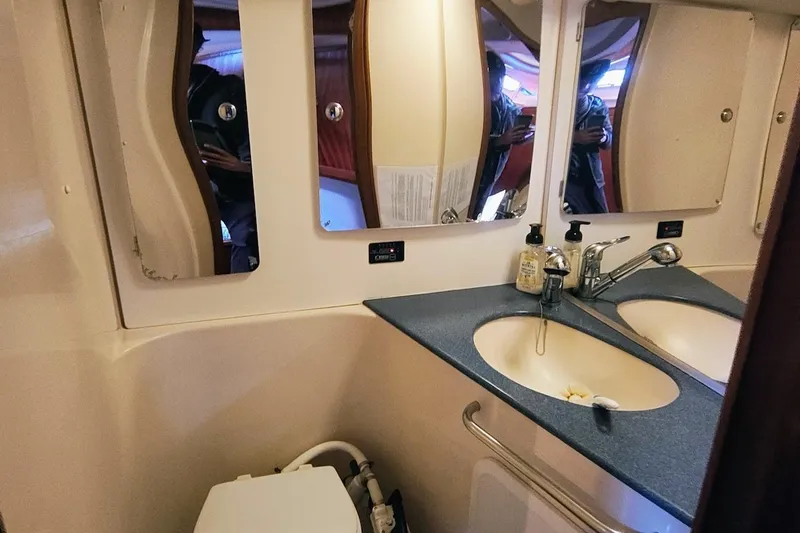 Slide: The Image of Bathroom interior of a 2003 Bavaria 49 yacht with dual sinks and mirrors. - 28