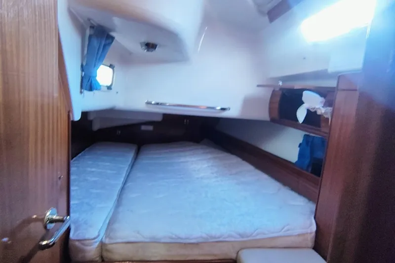 Slide: The Image of Cozy cabin interior of 2003 Bavaria 49 yacht with double bed and wooden finish. - 29