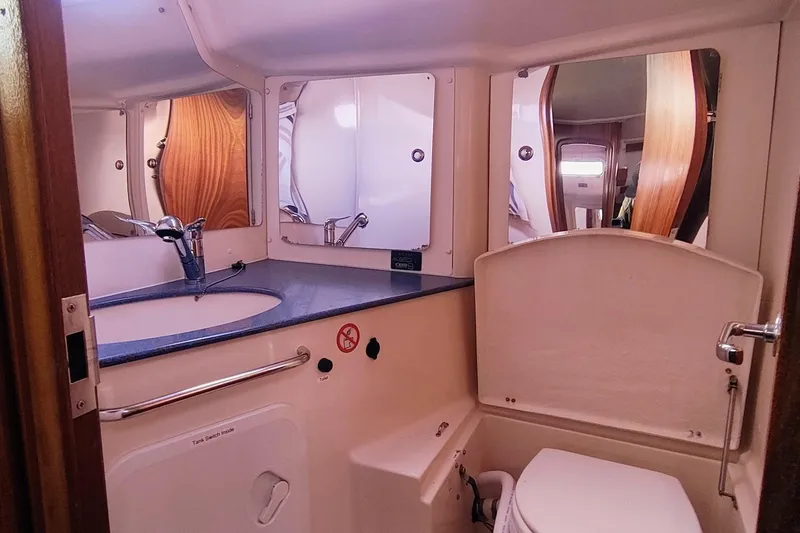 Slide: The Image of Bathroom interior of a 2003 Bavaria 49 yacht, featuring sink and toilet. - 30
