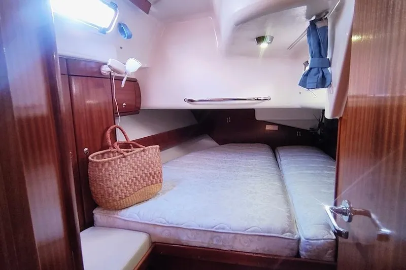 Slide: The Image of Cozy cabin interior of 2003 Bavaria 49 yacht with wooden finish and comfortable bedding. - 31