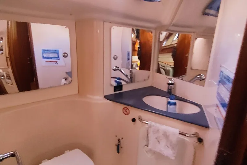 Slide: The Image of Bathroom interior of a 2003 Bavaria 49 yacht with sink and mirrors. - 32