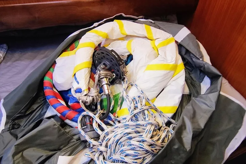 Slide: The Image of Coiled ropes and sailing gear inside a Bavaria 49 yacht, model year 2003. - 33