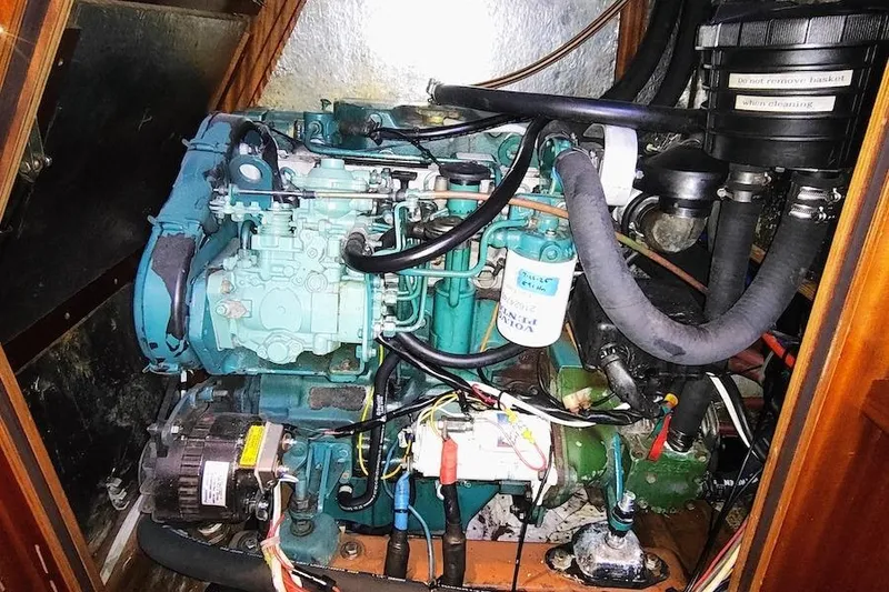 Slide: The Image of Engine compartment of a 2003 Bavaria 49 sailboat, showcasing mechanical components and wiring. - 34