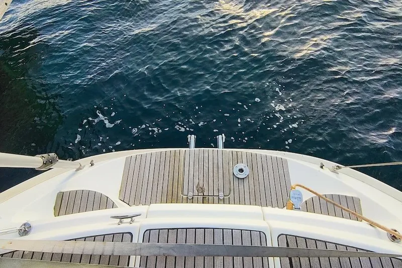 Slide: The Image of Deck view of 2003 Bavaria 49 yacht overlooking calm blue water. - 6
