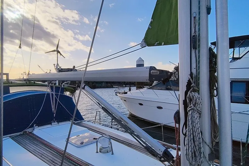 Slide: The Image of Sailboat Bavaria 49, 2003 model, docked with wind turbine and clear sky. - 7