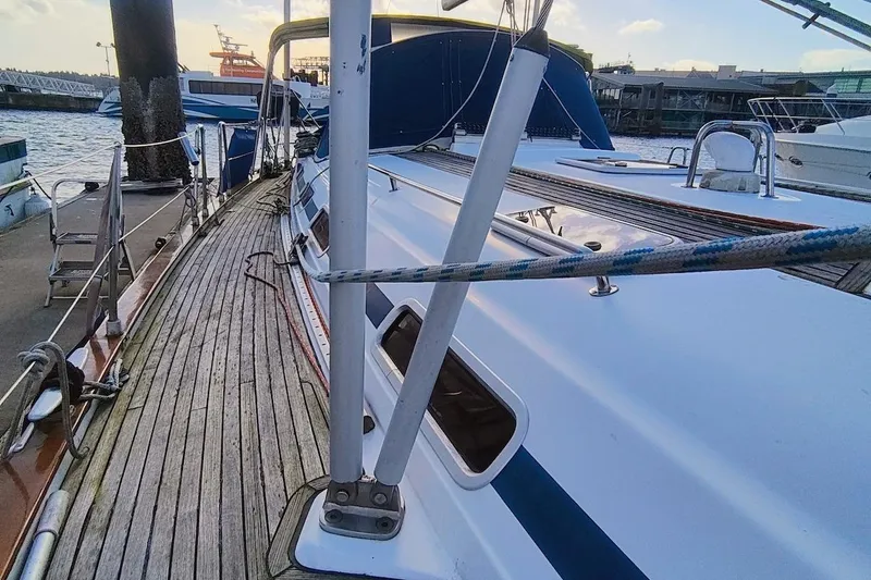 Slide: The Image of 2003 Bavaria 49 sailboat docked at marina, showcasing deck and rigging. - 8