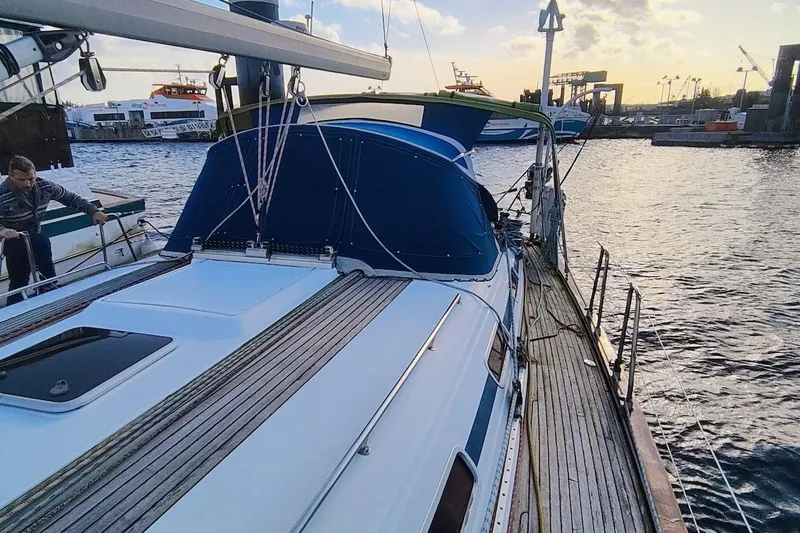 Slide: The Image of Sailing yacht Bavaria 49, 2003 model, docked at a marina during sunset. - 9