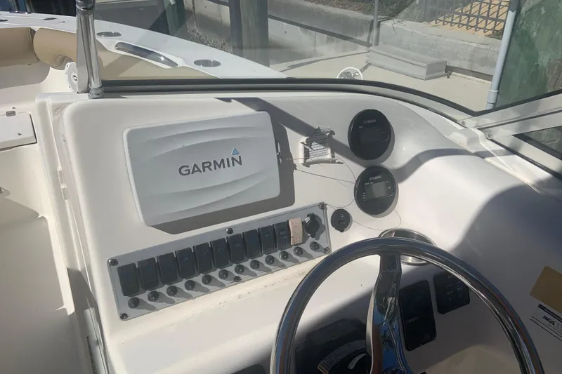 Slide: The Image of 2016 Key West 239 DFS boat dashboard with Garmin navigation system and steering wheel. - 10