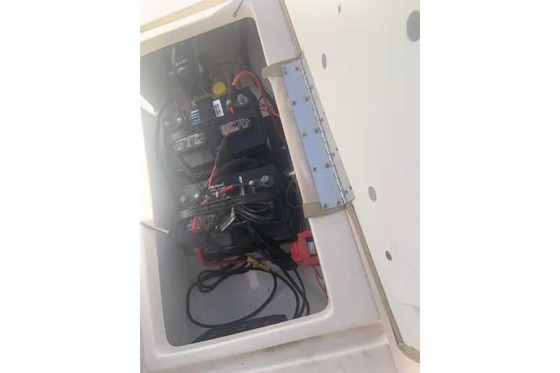 Slide: The Image of Battery compartment of a 2016 Key West 239 DFS boat, showing wiring and connections. - 11