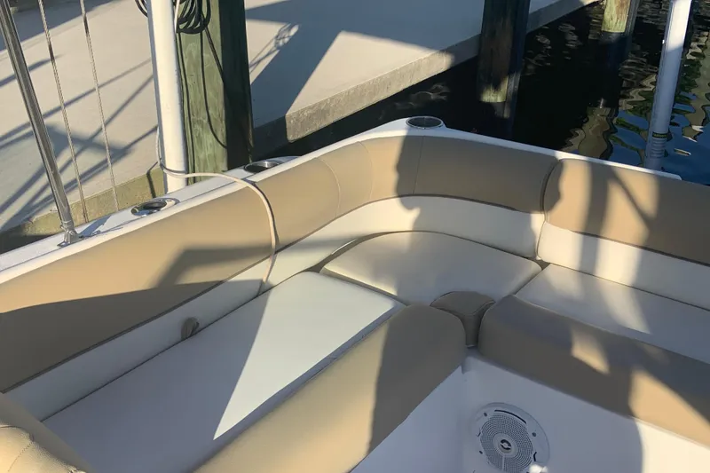 Slide: The Image of 2016 Key West 239 DFS boat interior with beige seating and dockside view. - 21