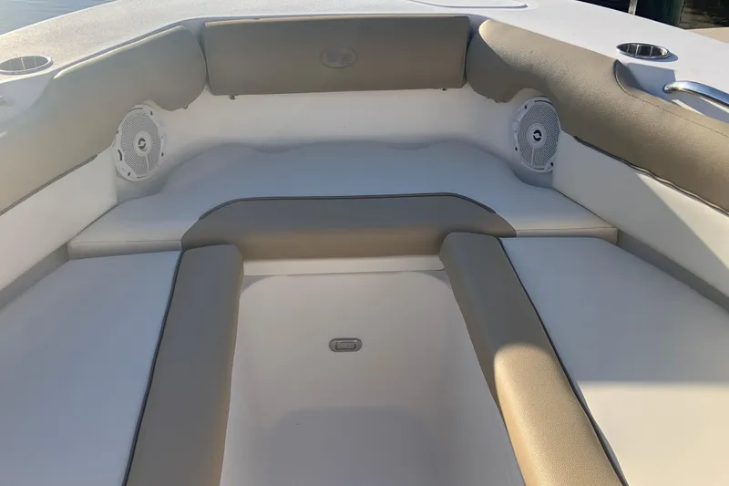 Slide: The Image of 2016 Key West 239 DFS boat interior with cushioned seating and built-in speakers. - 29