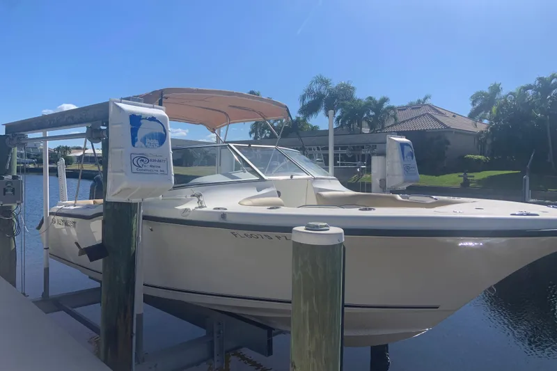 Slide: The Image of 2016 Key West 239 DFS boat docked on a sunny day, surrounded by palm trees. - 3
