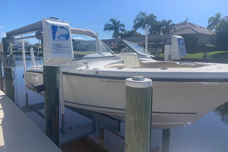 Slide: The Image of 2016 Key West 239 DFS boat docked on a lift by a waterfront home. - 5