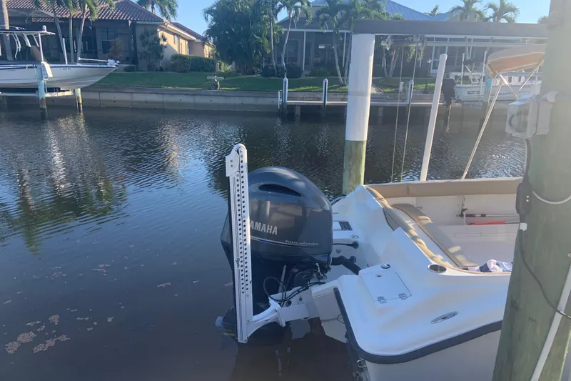 Slide: The Image of 2016 Key West 239 DFS boat with Yamaha F200XD outboard motor docked by waterfront homes. - 6