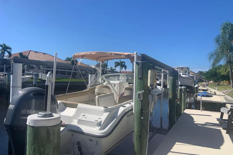 Slide: The Image of 2016 Key West 239 DFS boat docked in sunny marina with palm trees. - 7