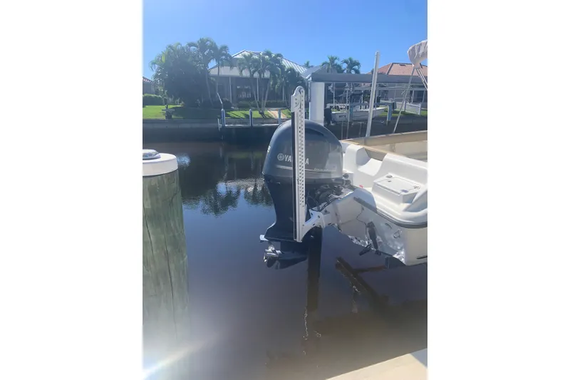Slide: The Image of 2016 Key West 239 DFS boat with Yamaha outboard motor docked by waterfront homes. - 9