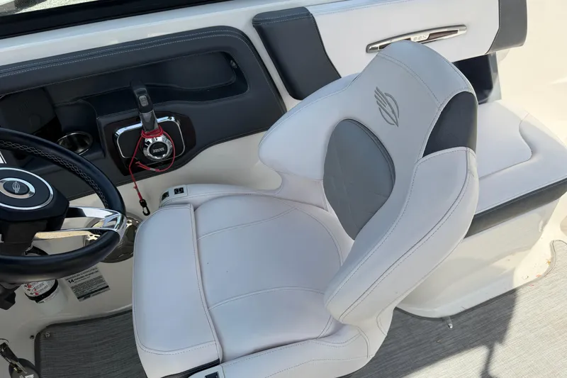 Slide: The Image of 2019 Chaparral 257 SSX boat interior with steering wheel and captain's seat. - 11