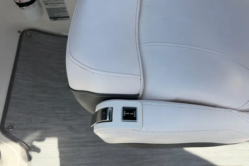 Slide: The Image of White leather seat with adjustable controls on a 2019 Chaparral 257 SSX boat. - 12