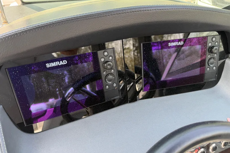 Slide: The Image of Dual Simrad displays on 2019 Chaparral 257 SSX boat dashboard. - 13