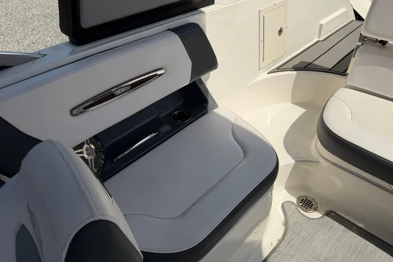 Slide: The Image of 2019 Chaparral 257 SSX boat interior seating with cup holder and speaker. - 15