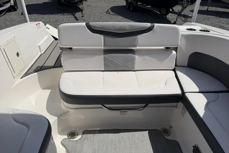 Slide: The Image of 2019 Chaparral 257 SSX boat interior with white and gray seating. - 16