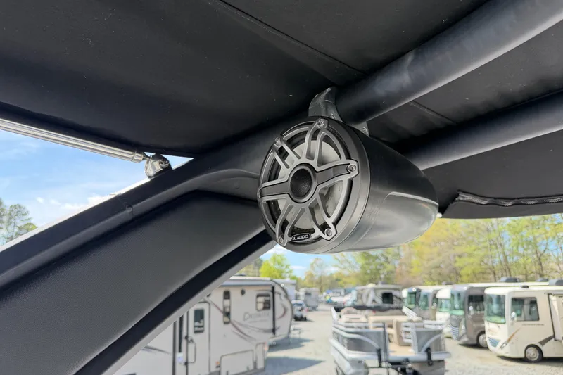 Slide: The Image of Speaker on 2019 Chaparral 257 SSX boat, with RVs in the background. - 21