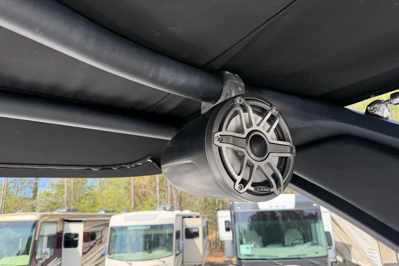 Slide: The Image of Speaker mounted on 2019 Chaparral 257 SSX boat, with RVs in the background. - 22