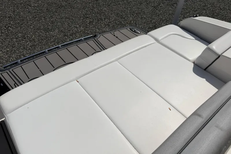 Slide: The Image of 2019 Chaparral 257 SSX boat with white cushioned seating and gray deck. - 23