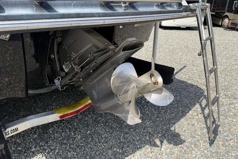 Slide: The Image of 2019 Chaparral 257 SSX boat propeller and ladder on gravel surface. - 24