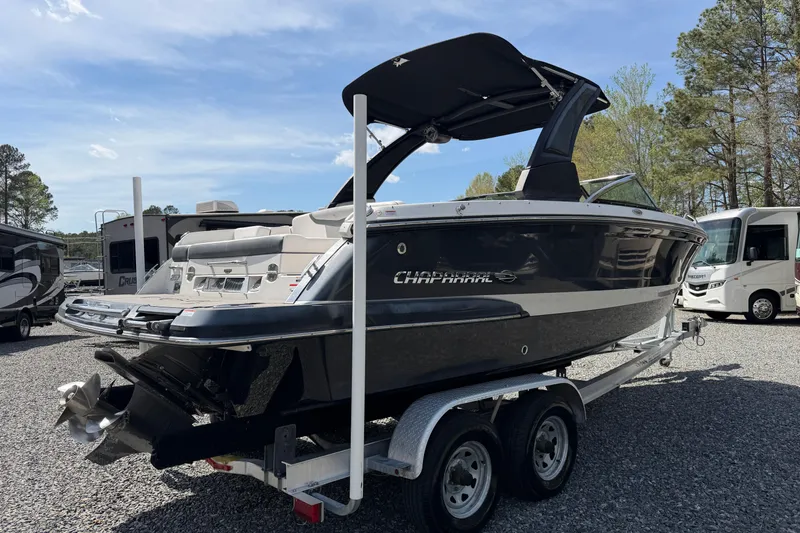 Slide: The Image of 2019 Chaparral 257 SSX boat on trailer, parked outdoors under clear sky. - 3