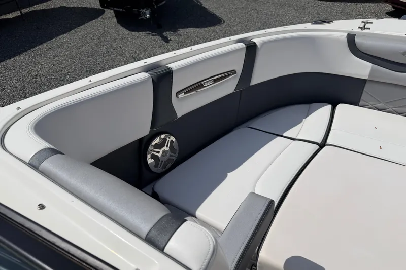 Slide: The Image of 2019 Chaparral 257 SSX boat interior with white cushioned seating and speaker. - 8