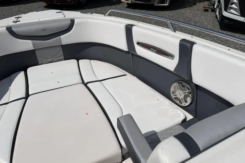 Slide: The Image of 2019 Chaparral 257 SSX boat interior with white and gray seating and speaker. - 9