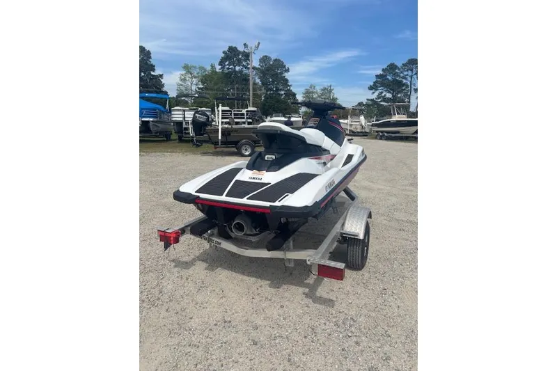 Slide: The Image of 2019 Yamaha WaveRunner EX on trailer, parked outdoors with boats in background. - 2