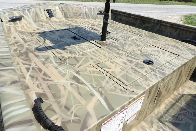 Slide: The Image of 2026 Crestliner 1760 Retriever SC boat with camouflage pattern, featuring storage compartments. - 10