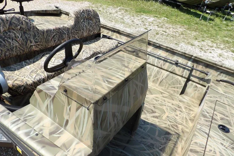 Slide: The Image of 2026 Crestliner 1760 Retriever SC boat with camouflage interior and steering console. - 12