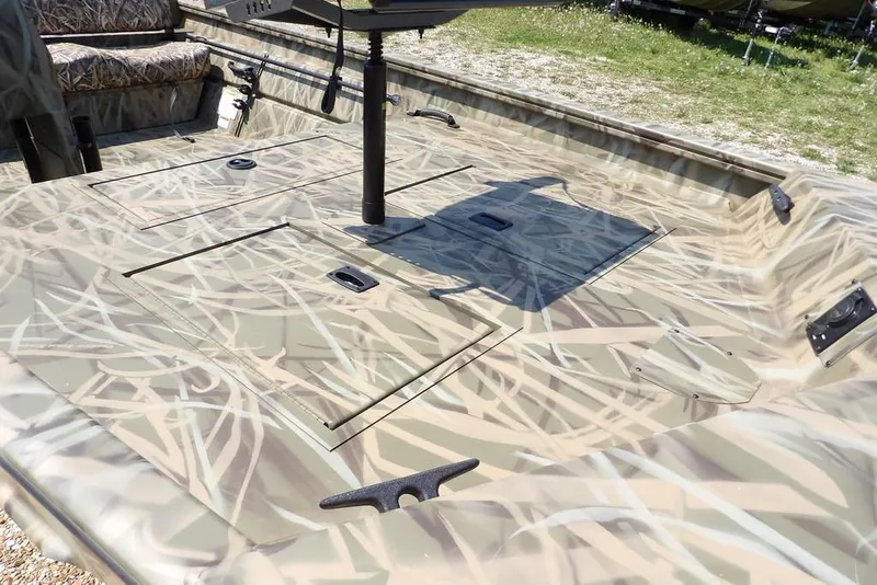 Slide: The Image of 2026 Crestliner 1760 Retriever SC boat with camouflage design and spacious deck. - 13