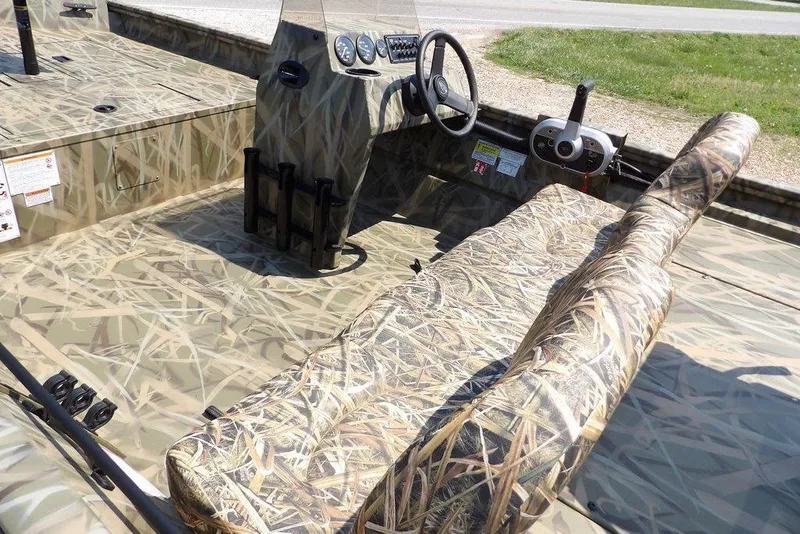 Slide: The Image of 2026 Crestliner 1760 Retriever SC boat interior with camouflage design and steering console. - 15