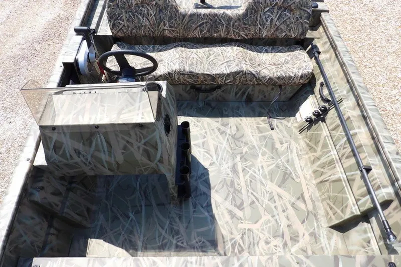 Slide: The Image of 2026 Crestliner 1760 Retriever SC boat interior with camouflage seating and steering console. - 16