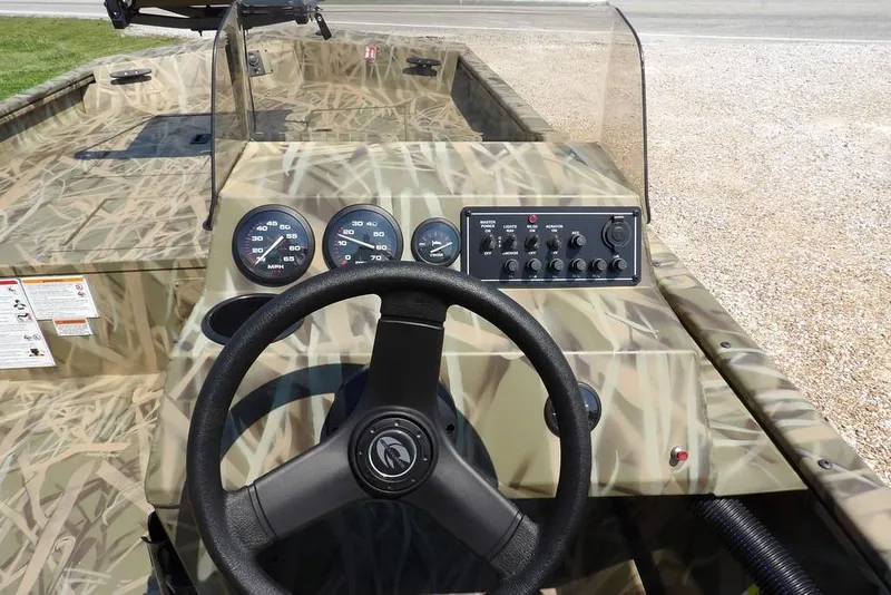 Slide: The Image of 2026 Crestliner 1760 Retriever SC boat dashboard with camouflage design and control panel. - 18