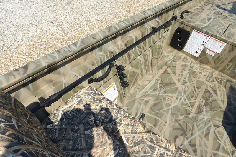 Slide: The Image of 2026 Crestliner 1760 Retriever SC boat interior with camouflage design and seating. - 19