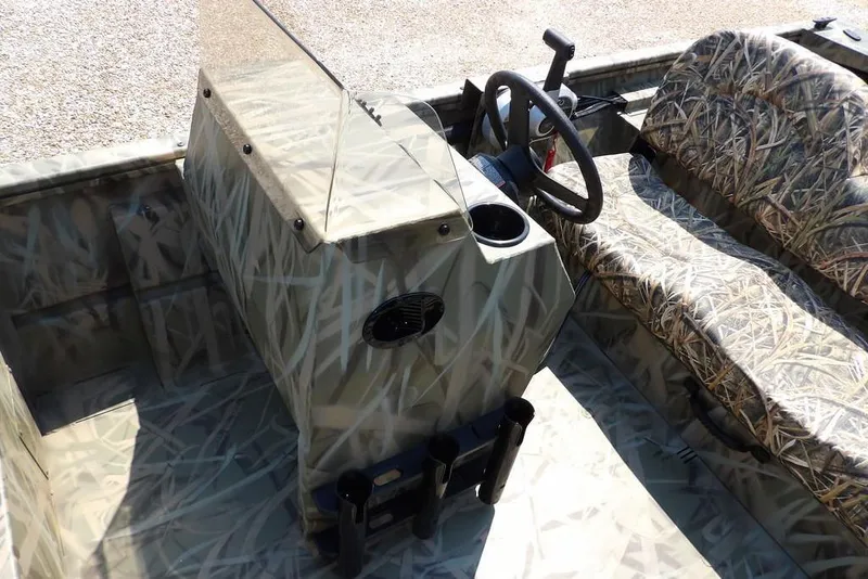 Slide: The Image of 2026 Crestliner 1760 Retriever SC boat interior with camouflage design and steering console. - 22