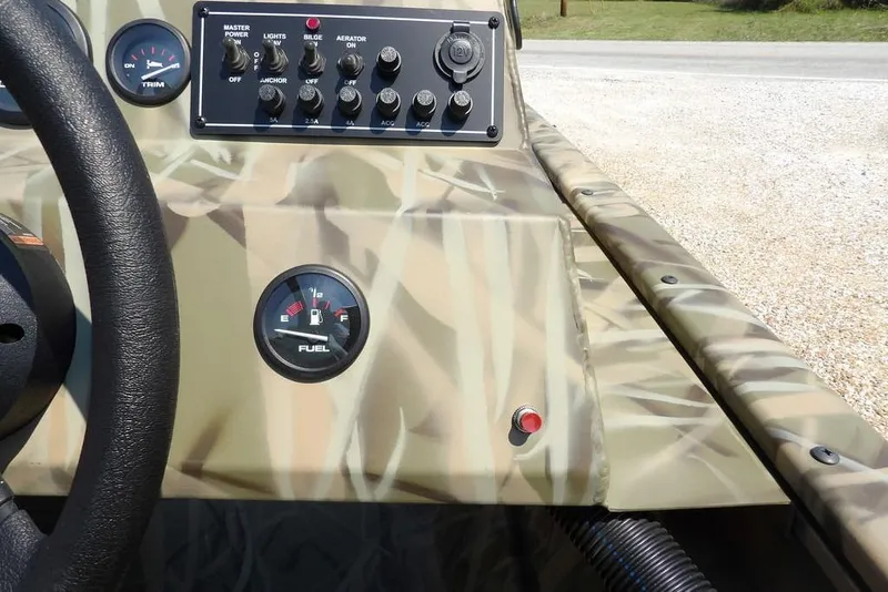 Slide: The Image of 2026 Crestliner 1760 Retriever SC dashboard with camo design and control panel. - 23