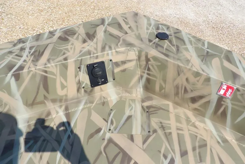 Slide: The Image of 2026 Crestliner 1760 Retriever SC boat with camouflage pattern and deck features. - 27