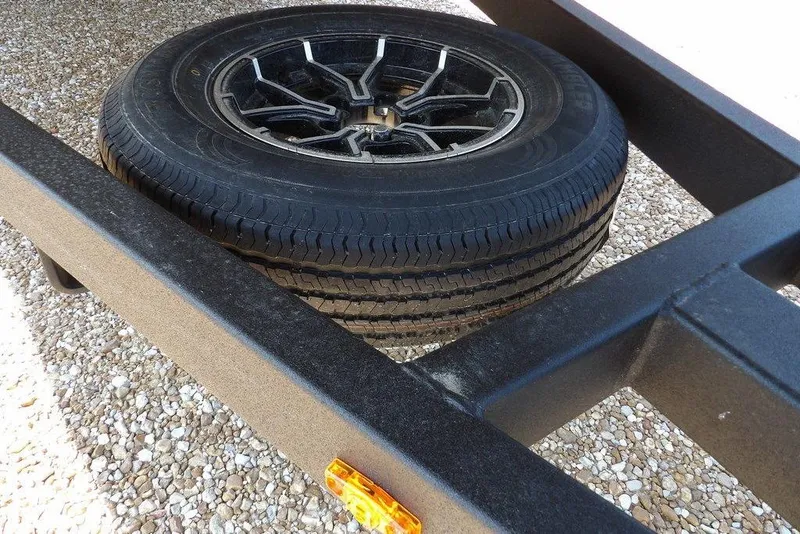 Slide: The Image of Trailer tire on Crestliner 1760 Retriever SC, 2026 model, resting on gravel surface. - 34