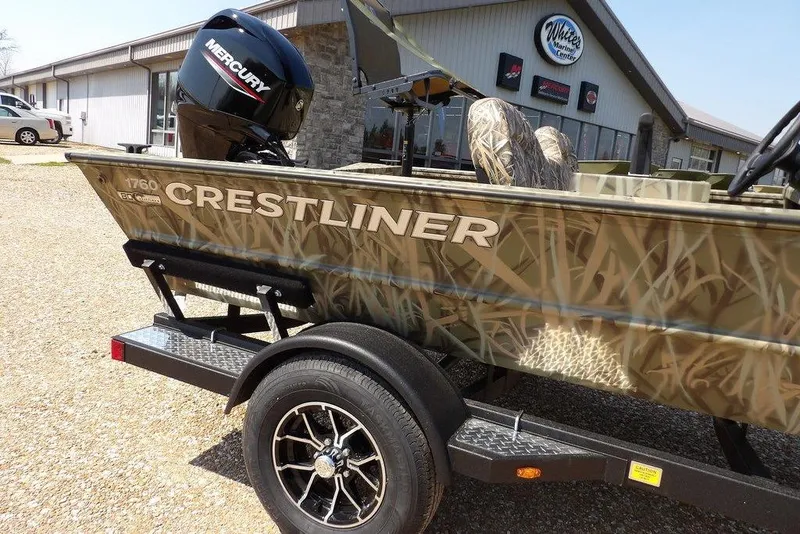 Slide: The Image of 2026 Crestliner 1760 Retriever SC boat with camouflage design on a trailer. - 35